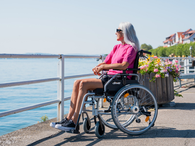 Woman in wheelchair with correct anti-decubitus seat cushion